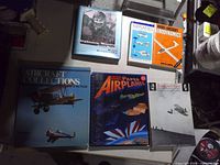 Front covers of six aviation books laid out on table