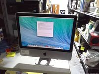 Front view showing powered-on iMac displaying setup screen