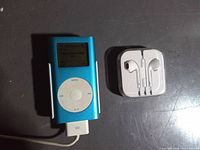 Front view of blue Apple iPod Mini next to EarPods case