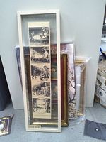 Stack of framed artworks, front comic strip print