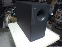 Front and side of black Bose AM-500 Acoustimass module