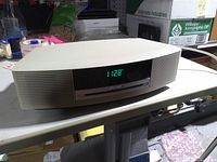 Front view showing display, speaker grille, CD slot