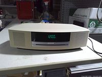 Front view showing display reading 12:00 and CD slot