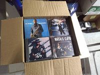 Open box showing top layer of four CDs