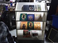 Full view of three-shelf display holding all eleven decorative arts books