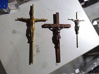 Overview of three crucifixes on table