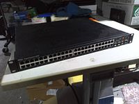 Front angled view of Dell PowerConnect 6248 showing all 48 RJ-45 ports and rack ears