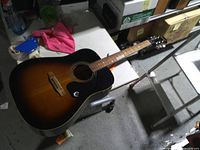 Full view of guitar front showing body, neck, finish, missing string