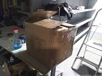 Closed cardboard shipping box on table