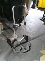 Hand truck standing upright with handle extended