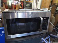 Front view showing stainless exterior, control panel, GE logo and door