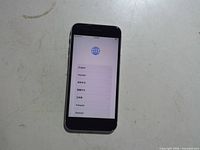 Front of white iPhone SE powered on to setup screen