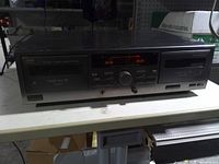 Front view of JVC dual cassette deck showing both tape doors, controls, display and branding