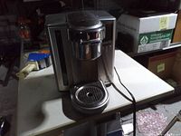 Front view of stainless Breville Keurig coffee maker on table