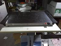 Front view of Kitchen Living buffet warming tray showing stainless surface, handles, indicator light and control knob