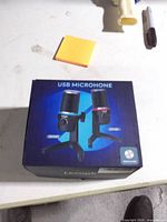 Front of retail box showing model and microphone images