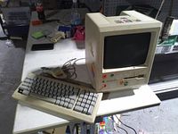 Front and side view of Macintosh Plus with keyboard and mouse