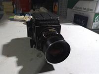 Front three-quarter view of Mamiya RB67 with lens attached
