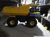 Left side profile showing yellow metal dump bed and Tonka Classic decal