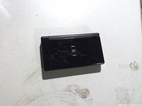 Closed black Nintendo DS Lite top view showing exterior condition