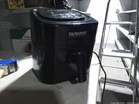 Front view of Nuwave Brio air fryer showing brand logo and handle
