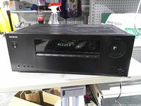 Front view showing display, missing volume knob and front input ports