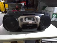 Front view of Philips boombox showing speakers, cassette deck, display and controls