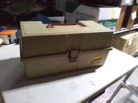Closed Plano beige tackle box front view showing logo and latch