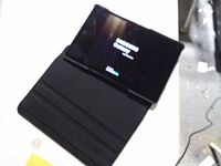 Tablet in folio case showing Samsung Galaxy boot screen