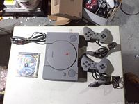 PlayStation One console, two controllers, Crash Team Racing disc