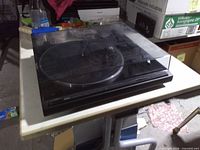 Full view of Yamaha TT-400U turntable with dust cover closed on table