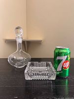 Decanter, ashtray, and soda can for scale