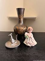 Front view showing vase, angel figurine, kangaroo dish