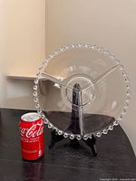 Front view of clear beaded-rim divided platter beside soda can for scale