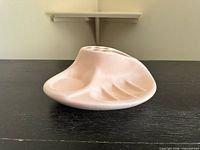 Top view of pink ceramic organizer showing compartments and brush holes