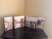 All four framed prints displayed on table