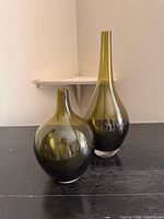 Both olive green glass vases front view