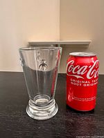 front view showing vase shape and bee motif beside soda can for scale