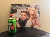 Front view of entire Wizard of Oz tin sign with 7-Up can for scale