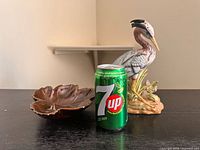 Heron figurine, leaf dish with 7UP can for scale