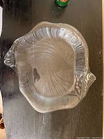 Top view of entire clear glass shell-shaped platter