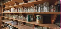 Shelved assortment of clear jars various sizes and lid types