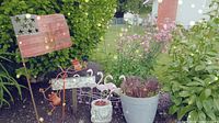 Group shot showing American flag stake, flamingo stake, frogs, concrete planter with succulents