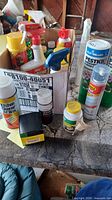 Overall lot showing box with multiple sprays and cleaners plus two tall Lilly Miller canisters