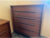 Front view of dresser with matching nightstand visible