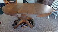 Full view of oak pedestal dining table with leaves inserted