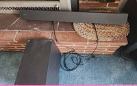Top view of Sony soundbar on mantel with subwoofer and cables beneath