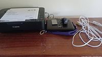 Canon Pixma printer, Sylvania DVD player, remote, adapter, cable laid out on table