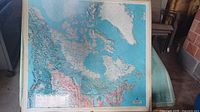 Full view of framed Canada relief map mounted on board