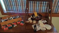 Overall lot with thread spools, Singer discs, buttons, lace, wood boxes and stand